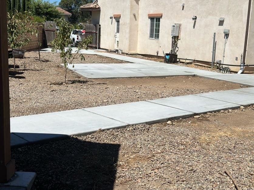 Wraparound concrete walkway at a Spanish-style San Diego home