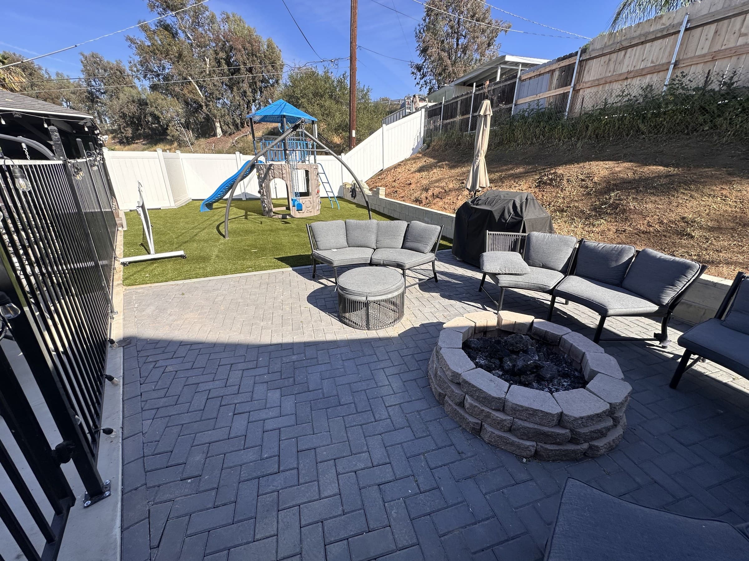 Stamped concrete patio with herringbone pattern and a built-in firepit