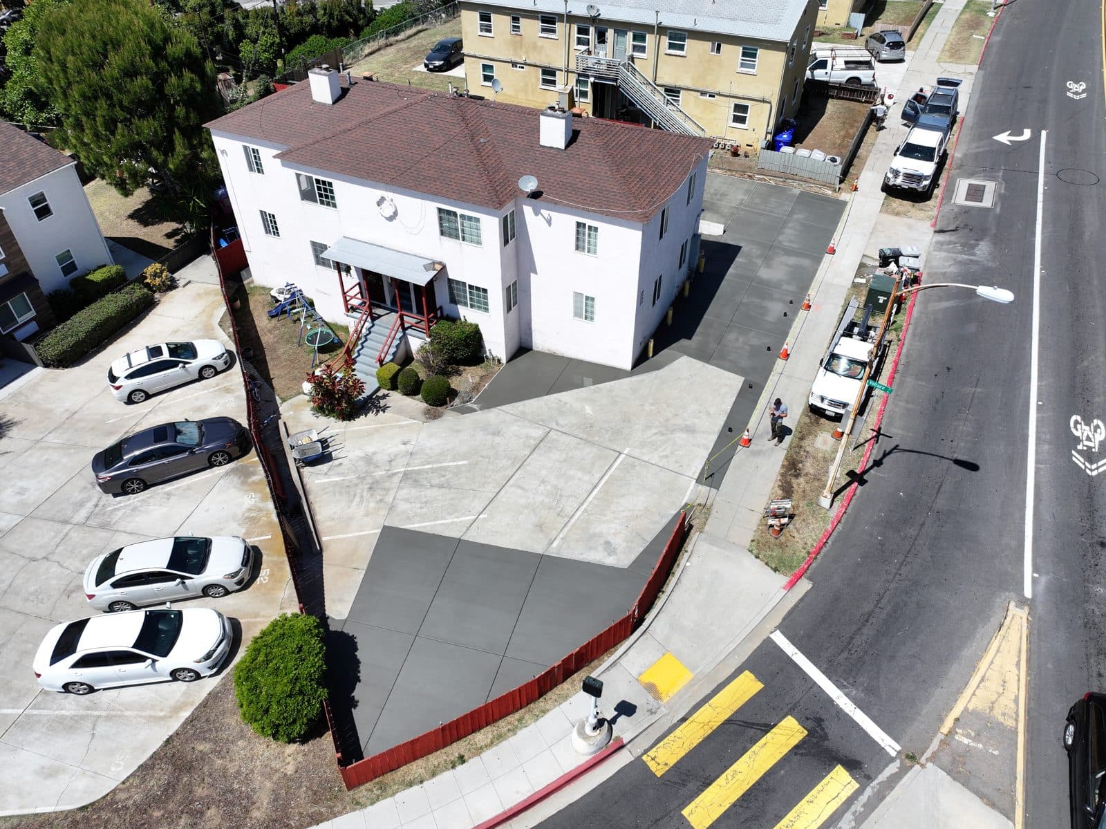 Aerial view of a new concrete driveway at a multi-unit property
