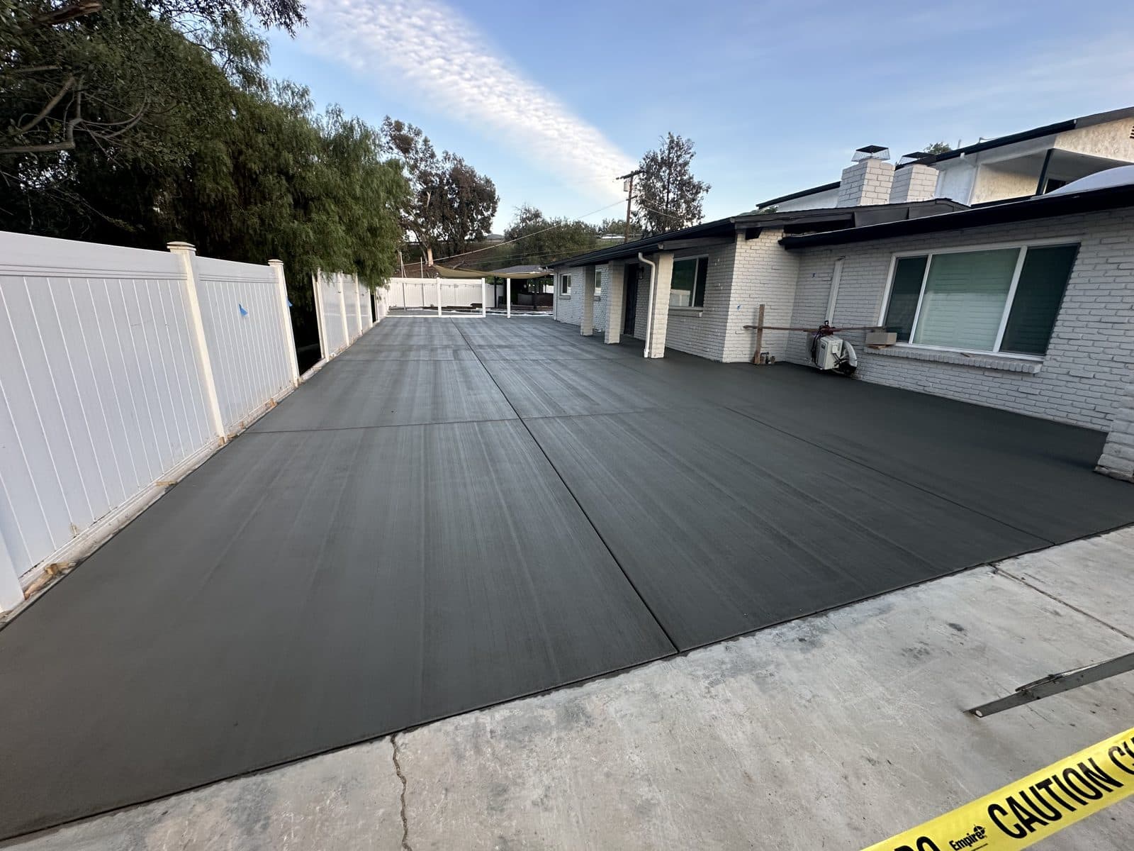 Wide concrete driveway and parking pad with clean broom finish
