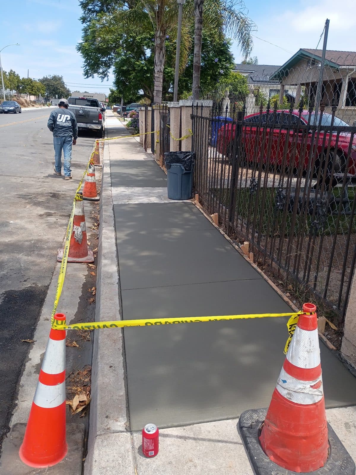 City-spec sidewalk panel replacement with safety cones during cure